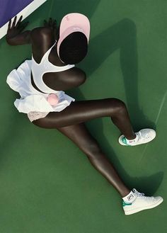 a female tennis player is laying on the court