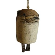 a wooden ornament with an animal face hanging from it's side on a rope