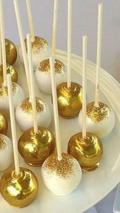 gold and white cake pops on a plate