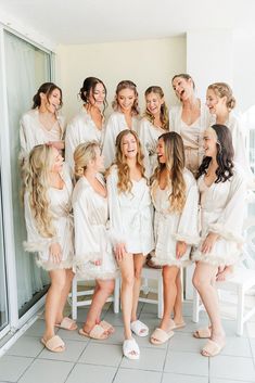 a group of women in white robes standing next to each other