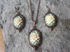 "For sale are beautiful flawless (perfect pale yellow rose on a green background) cameo pendant necklace and matching earrings set The cameos are gorgeous, very detailed They are offered at a reasonable price, make perfect gifts, and are wonderful quality The cameos are set in pretty copper settings. The chain is a 20\" 2mm bronze rolo link chain, with a lobster claw clasp Timeless classic look Wonderful gifts I make several varieties, colors, styles and matching sets I will be glad to do specia Victorian Rose Design Jewelry For Formal Occasions, Victorian Green Cameo Jewelry, Antique Green Cameo Jewelry, Green Jewelry With Rose Design For Gift, Green Jewelry Gift With Rose Design, Green Rose Design Jewelry For Gift, Cameo Pendant Necklace, Cameo Jewelry, Cameo Pendant