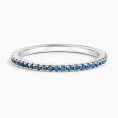 a white gold band with blue and green stones