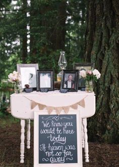 a table that has pictures on it and two framed photos sitting on top of it