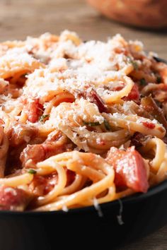 a pan filled with pasta and meat covered in parmesan cheese