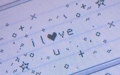 an old computer keyboard with the word love written on it and a heart in the middle