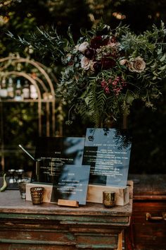 a table with menus and flowers on it