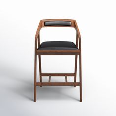 a wooden chair with a black leather seat and back rest on an isolated white background