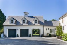 a large white house with two garages