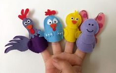 hand with five finger puppets in the shape of birds