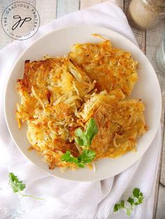 a white plate topped with hash browns and parsley