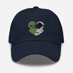 Get ready for an intergalactic fashion statement with our Alien & Astronaut Dad Hat! Handmade and adjustable, this baseball cap features a unique embroidery design of an alien and astronaut in a heart shape. The 6-panel design offers a comfortable fit for all, making it a unisex accessory. Available in multiple colors, this hat is perfect for space-loving couples or as a gift. The soft, durable fabric and adjustable strap ensure comfort for any adventure. Add a touch of sci-fi to your daily styl Intergalactic Fashion, Alien Astronaut, Loving Couples, Unique Embroidery, Space Gift, Embroidered Hat, Hat Handmade, Quality Hats, Embroidered Hats