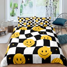 a black and white bed with yellow smiley faces on it