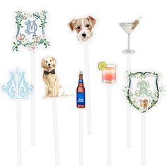 a set of four cake toppers with dogs on them and drinks in the background