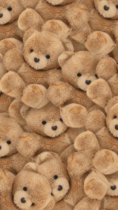 a group of brown teddy bears sitting next to each other