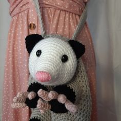 a crocheted stuffed animal is hanging from a dress with polka dots on it