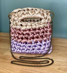 Luxurious Handcrafted Crochet Handbag - Made with 100% Polyester Ribbon Indulge in the perfect blend of elegance and craftsmanship with our handcrafted crochet handbag, meticulously designed using soft and sophisticated 100% polyester fabric ribbon. This unique material offers a luxurious feel while providing durability and resilience, making it ideal for your everyday adventures or special occasions. The handbag's intricate design captures the essence of a timeless style with a modern twist, making it a versatile accessory for any outfit. Whether you're heading to a resort getaway or a date night in the city, this handbag will elevate your style effortlessly. With its spacious interior and sturdy construction, you can carry your essentials in style without compromising on comfort. Each pi Elegant Woven Crochet Crossbody Bag, Elegant Evening Crochet Bag With Braided Handles, Elegant Crochet Bag With Braided Handles For Evening, Elegant Square Crochet Bag, Elegant Square Woven Crochet Bag, Elegant Crochet Top Handle Shoulder Bag, Elegant Top Handle Crochet Shoulder Bag, Elegant Square Crochet Bag With Braided Handles, Elegant Crochet Crossbody Bag With Braided Handles