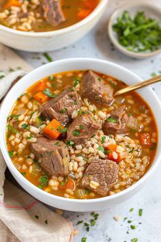 two bowls filled with beef and barley soup