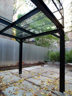 an empty patio with lots of leaves on the ground