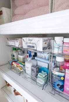 an organized bathroom shelf filled with toiletries and hygiene products