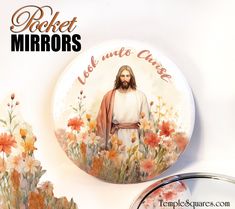 a button with the image of jesus surrounded by flowers and daisies, on a white background