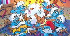 the smurfs are gathered together in front of a birthday cake with candles on it