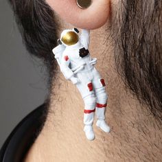 Introducing our Hand-Painted 3D Printed Astronaut Earrings: Size: Length: 1.8 in; Width: .5 in Weight: 3 grams for each earring. 100% Handmade with attention to detail Hypoallergenic Stud made of Surgical Steel Unique 3D Printed design Each pair is hand-painted to order Slight variations may occur due to handmade nature Embark on a cosmic journey with our extraordinary 3D-printed astronaut earrings. Explore our stellar collection of exquisite designs that showcase the wonders of space. Elevate y Stocking Filler Earrings Geek, Astronaut Earrings, Starter Earrings, Space Earrings, Funky Gifts, Rocket Launch, Astronaut Space, Whimsical Jewelry, Weird Gifts