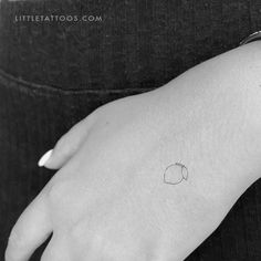 a small apple tattoo on the left hand is shown in this black and white photo