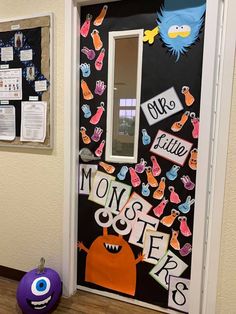 a door decorated with magnets and paper monsters on the front, along with other decorations