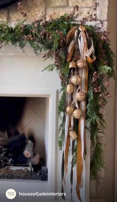 the fireplace is decorated with greenery and ribbons