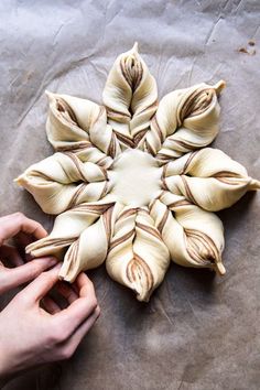 a person is holding some food in front of a star shaped object on wax paper