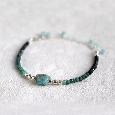 "Raw Apatite and Shaded Blue Tourmaline Bracelet. October birthstone gift. Skinny, Boho Style Multi Gemstone Bracelet.  Created using beautiful, micro faceted  shaded Tourmaline beads, paired with stunning, aqua blue, raw Apatite stone and a bright, shiny sterling silver or 14k gold filled spacer beads. These natural AA grade  Tourmaline beads are gorgeous - beautiful ombre shades of pale and dark, almost black blue which are emphasised by their tiny facets.  This multi gemstone bracelet is adjustable in size, between 5.5\" - 8\".  The 2.5\" extension chain is decorated with few dangling, faceted, aqua blue apatite gemstone beads. This natural gemstone bracelet looks amazing on its own or layered with other bracelets. A beautiful addition to your individual, bohemian style. Natural gemston Apatite Natural Stone Bracelets As Gift, Tourmaline Bracelets With Natural Stones, Tourmaline Natural Stones Bracelets As Gift, Adjustable Tourmaline Gemstone Bracelets, Apatite Bracelets With Natural Stones In Round Beads, Adjustable Tourmaline Gemstone Bracelet, Turquoise Apatite Spiritual Bracelets, Spiritual Tourmaline Gemstone Beaded Bracelets, Blue Spiritual Bracelets With Birthstone