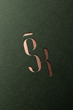 the letter s and k is cut out from a green box with metallic foil on it