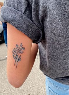 a woman with a flower tattoo on her arm