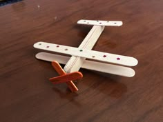 a wooden toy airplane sitting on top of a table