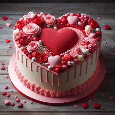 a heart - shaped cake with roses and icing on a wooden table next to confetti