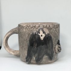 a ceramic mug with a monkey on it