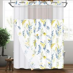 a shower curtain with yellow and blue flowers on it