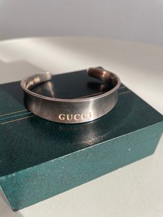 Vintage Gucci sterling silver 925 cuff bracelet with engraved Gucci at the centre. ★ Measurements: length: 9.25" ★ Label/Designer: Gucci made in Italia 925 ★ Condition: excellent Shipping Is Avaliable Worldwide. Every item is carefully shipped Priority via Air Mail - shipping takes from 7 to 14 working days, depending on your location. Shipping includes Tracking. ✩ visit the shop ✩ https://www.etsy.com/shop/Themagicstories2?ref=seller-platform-mcnav Thanks! Luxury Engraved Round Cuff Bracelet, Luxury Engraved Cuff Bracelet For Anniversary, Luxury Silver Cuff Jewelry, Luxury Engraved Cuff Bangle Bracelet, Luxury Engraved Bangle Cuff Bracelet, Luxury White Gold Cuff Bracelet Gift, Luxury White Gold Cuff Bracelet As Gift, Designer Cuff Bracelet Bangle As Gift, Luxury Silver Cuff Bracelet