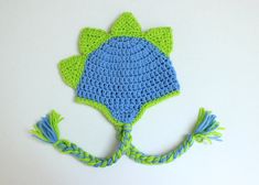 a crocheted blue and green hat with tassels