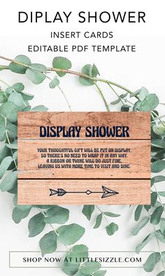 a wooden sign that says display shower next to some green leaves on a white background