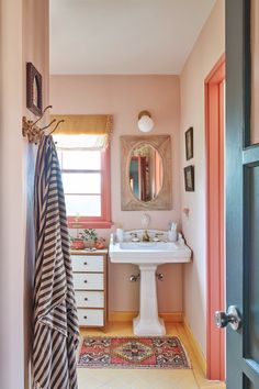 an instagram page with the image of a bathroom in pink and white, including a sink