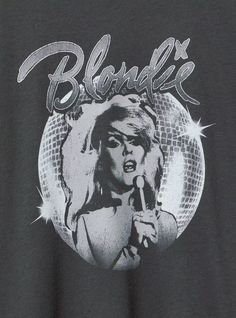 a woman holding a microphone in front of a disco ball with the words blonde on it