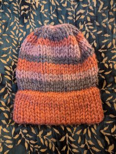 A handmade knit hat from a mix of Lion Brand's recycled polyester.  One size fits most! Striped Hat, Handmade Knit, Orange Roses, Lion Brand, Handmade Knitting, Pink And Purple, Knit Hat, Orange Pink