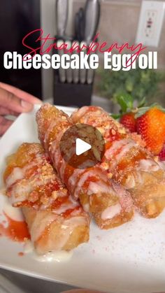 a white plate topped with cheesecake eggrolls and strawberries