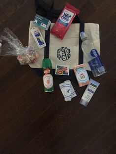 the contents of a tote bag laid out on a wooden floor