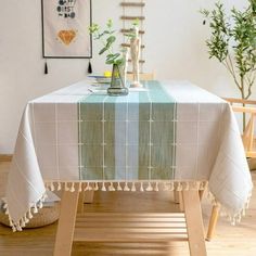 a table with a green and white checkered tablecloth on it in a room