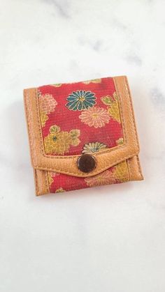 "This is a vintage leather Hato Hasi coin purse with a button snap. Hallmarks: Hato Hasi Measures 3\" x 3\" Weighs .5 oz. All measurements are approximate.  Condition: Good vintage condition. Normal wear associated age. A few light surface scratches and slight discoloration. Pouch has a distinct perfume smell. Please see photos. Sold as is. Priced accordingly.  Please look over carefully and inspect any and all photos. Our shop is committed to fully disclosing all items' conditions and history with as great of detail as possible.  Please keep in mind; what constitutes as new or unused condition for older era jewelry differs from non-vintage pieces; please consider this when examining all items in our shop. Simple wear and tear is normal for all vintage pieces. I will refund any shipping ov Vintage Brown Bifold Coin Purse, Vintage Brown Wallet With Coin Pocket, Vintage Brown Trifold Wallet With Coin Pocket, Brown Vintage Wallet With Coin Pocket, Brown Rectangular Coin Purse With Snap Closure, Vintage Brown Wallets With Card Slots, Vintage Wallets With Snap Closure, Vintage Wallets With Snap Closure For Everyday Use, Travel Bifold Coin Purse With Snap Closure