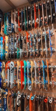 many skateboards are lined up on the wall