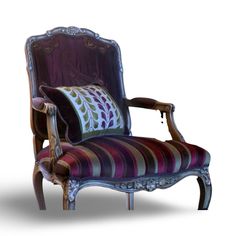 an old fashioned chair with a striped cushion on the armrests and back rest