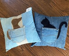 two pillows made to look like jeans with a cat in the pocket